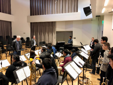 Picture of a jazz band working with Beatty and Mayse, guest artists, in a room at the Coil School for the Arts